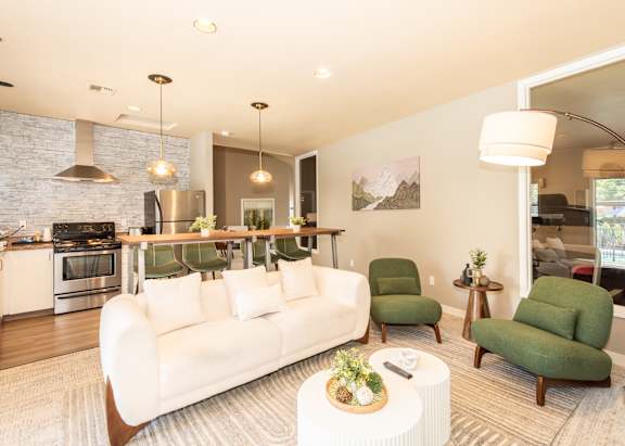 A modern living room with a white couch and green armchairs at Sunstone Parc, Beaverton, OR, 97008