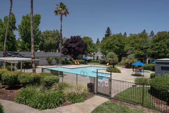 swimming pool fenced exterior at Woodbridge Apartments, Sacramento, California 95833