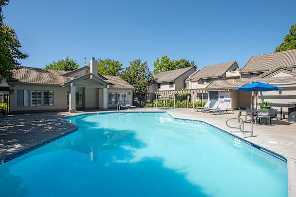 A swimming pool and clubhouse at Zinfandel Village Apartments, California, 95670