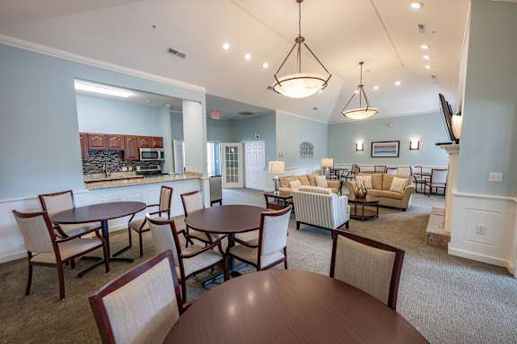A living room with a dining table and chairs.