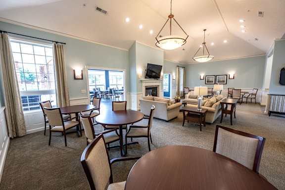 A living room with a brown table and chairs.