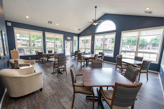 A large room with a table and chairs.