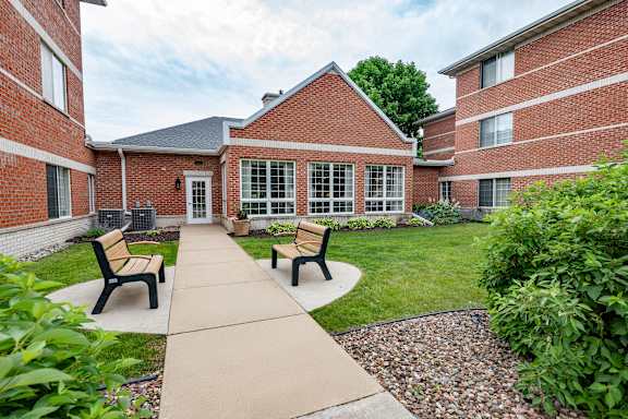A red brick building with a walkway in front.