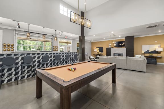 a pool table in the clubhouse at ascend at woodbury new luxury apartments in woodbury m