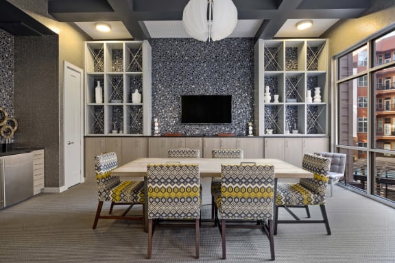 a conference room with a table and chairs and a television