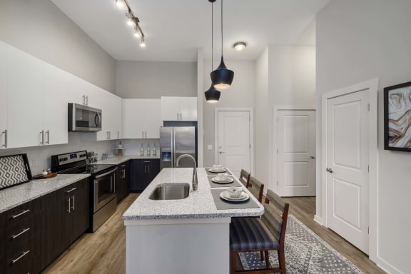 a kitchen and dining room with an island and a sink