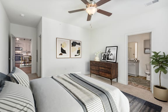 a bedroom with a bed and a ceiling fan