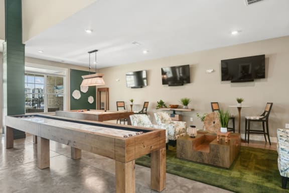 a living room with a pool table and a tv