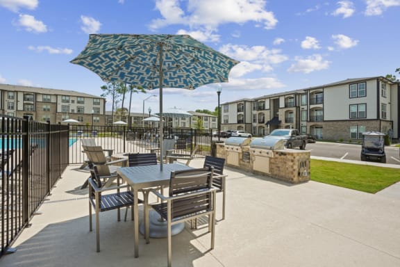 our apartments offer a patio with tables and chairs and a pool