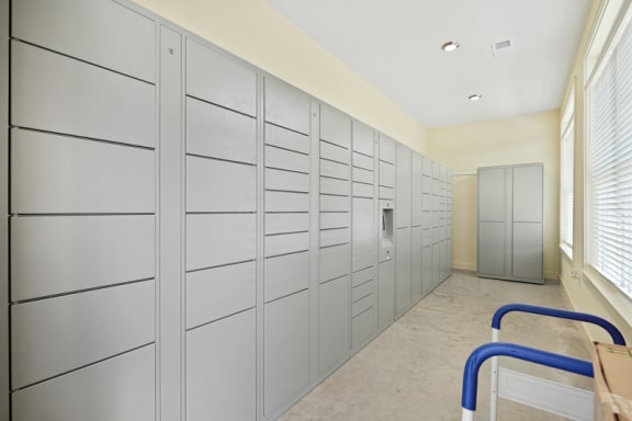 a long hallway with many lockers and a door