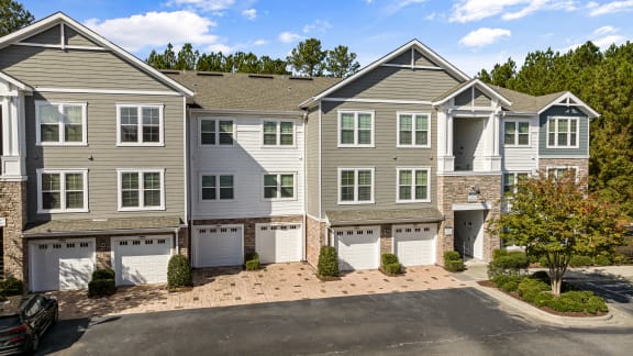 an image of an apartment building with garage doors