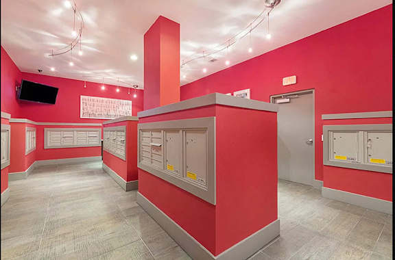 a large room with red walls and mailboxes