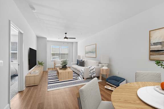 A living room with a sofa set, a coffee table, and a television.