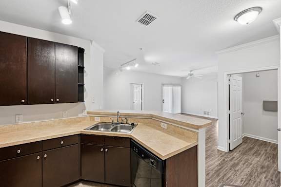 A kitchen with brown cabinets and a wooden countertop.