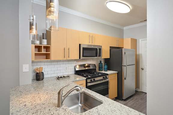 a kitchen with stainless steel appliances and granite counter tops