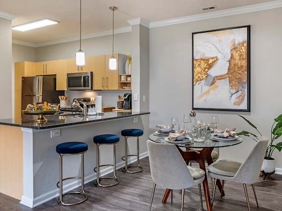 an apartment kitchen and dining area with a table and chairs