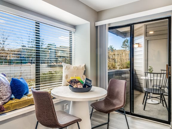 Dining room with large windows and sliding door to balcony