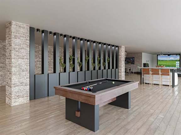 Recreation room with pool table and bar seating at Garden at 3Roots Apartments, San Diego, CA