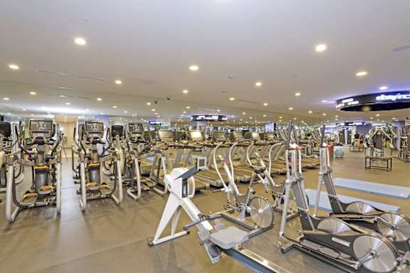 Large fitness center with cardio and strength equipment at Torrey Gardens Apartments, San Diego, CA 92130