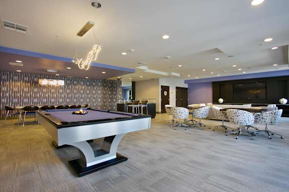 Recreation room with billiards and lounge furniture at Torrey Gardens Apartments, San Diego