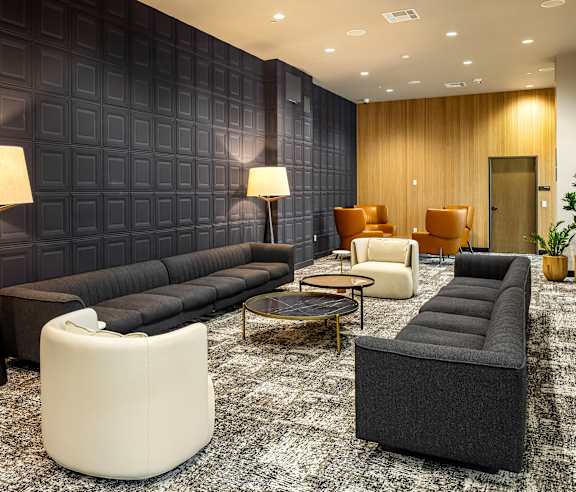 Modern lounge with paneled walls and contemporary seating at Elements Apartments, Irvine, 92612