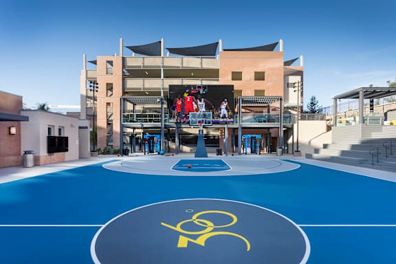 Outdoor basketball court with large video screen at 360 Luxury Apartments, San Diego, CA 92122