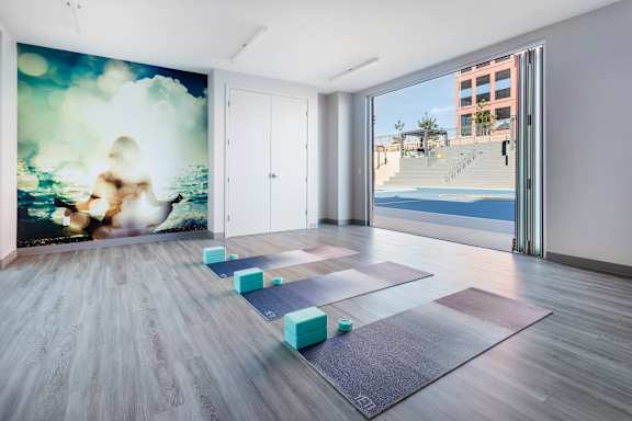 Yoga studio with mats and ocean mural at 360 Luxury Apartments, San Diego, 92122