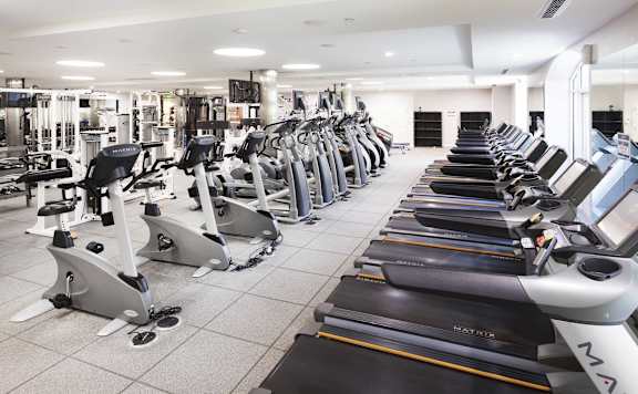 A gym with treadmills and elliptical machines.