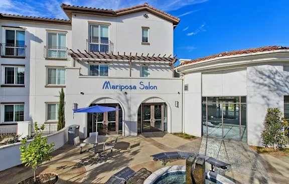 Mariposa salon entrance with outdoor seating area at Torrey Gardens Apartments, San Diego, CA 92130