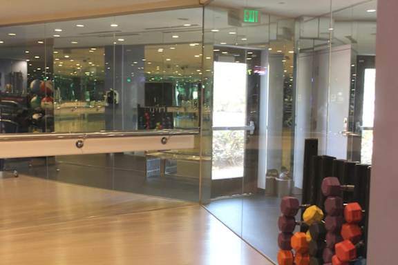 Fitness studio with ballet barre and mirrored walls at Torrey Gardens Apartments, San Diego, California