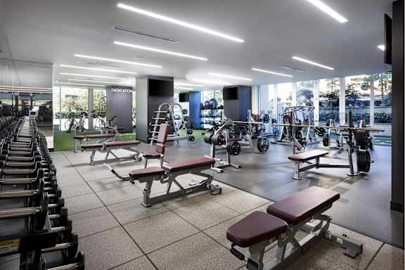 Fitness center with free weights and bench stations at LUX by Garden* Apartments, California