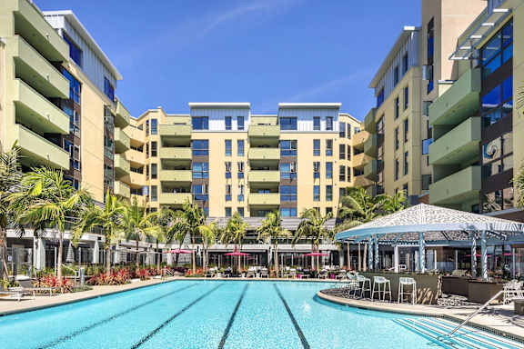 Lap pool courtyard with surrounding residential buildings at Metropolis Apartments, California, 92614