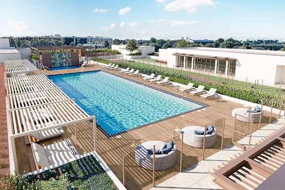 Rooftop pool area with wooden deck and shaded cabanas at Garden at 3Roots Apartments, San Diego