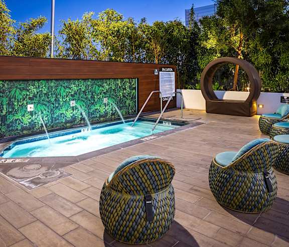 Spa with lounge seating and circular sculpture at Elements Apartments, Irvine, California