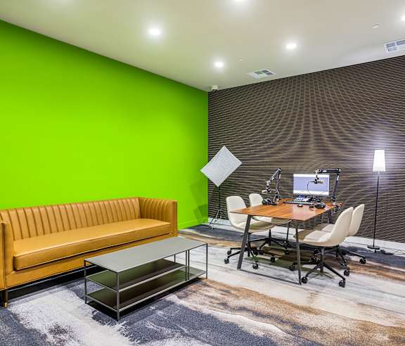 Workspace with desk and lounge seating area at Elements Apartments, Irvine, California