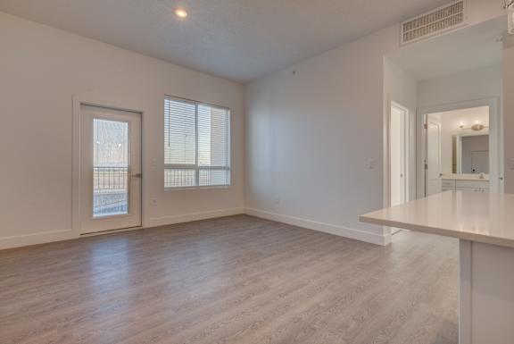 A spacious room with a door and a window.