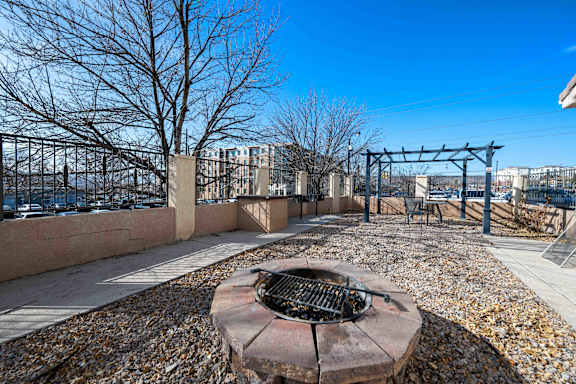 A fire pit sits in the middle of a gravel area.