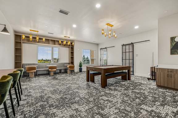 A room with a grey carpet and a wooden table.