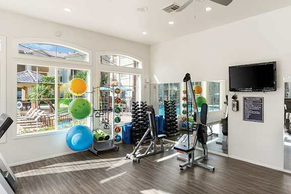State-of-the art fitness center with weights and yoga equipment - Sonterra Apartments at Paradise Valley