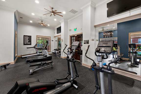 Fitness center with cardio and weight equipment - Belle Harbour Apartments