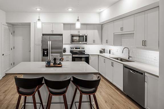 Chrome plumbing fixtures in kitchens - The Remy Apartments