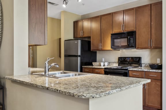 Granite countertops in all kitchens - Acadia at Cornerstar Apartments