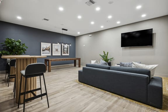 Resident lounge with multiple large-screened TVs - Acadia at Cornerstar Apartments