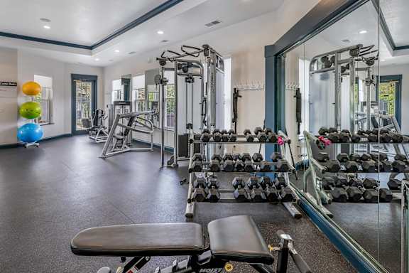 Fully-equipped fitness center with weights - Lantern Woods Apartments