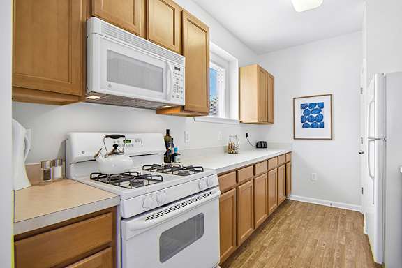 Spacious kitchens with gas range and built-in microwave - Avenel at Montgomery Square