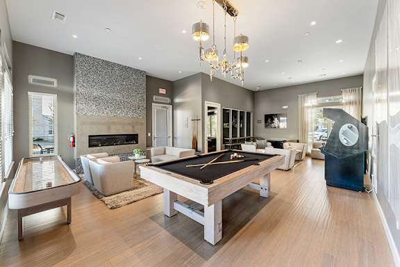 Game room with billiards, indoor shuffleboard and arcade games - Everlee