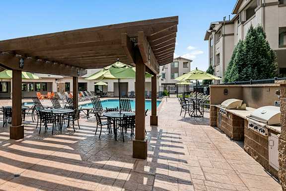 Poolside BBQ station with gazebo seating - First and Main Apartments