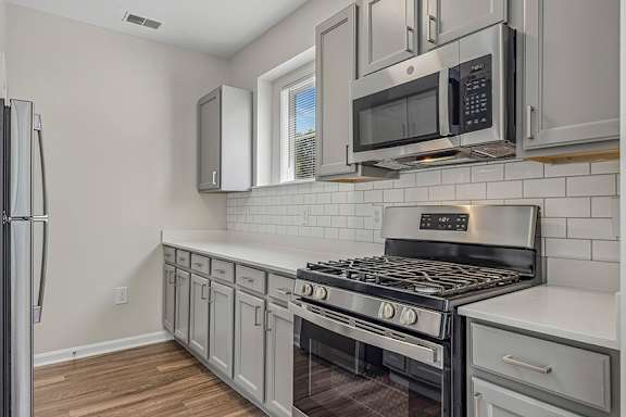Stainless steel appliances available including stove range and microwave - Avenel at Montgomery Square
