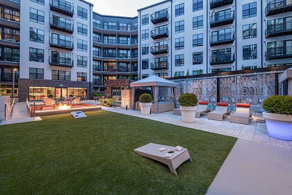 Courtyard lounge with lawn games and sunken fire pit - Rockwell at Crown