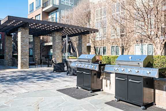 Outdoor entertainment space with dining and grilling area - The Perry